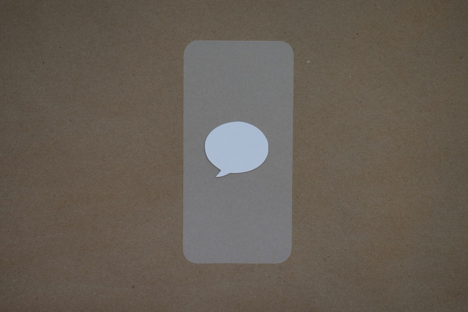 a white speech bubble sticker on a brown background